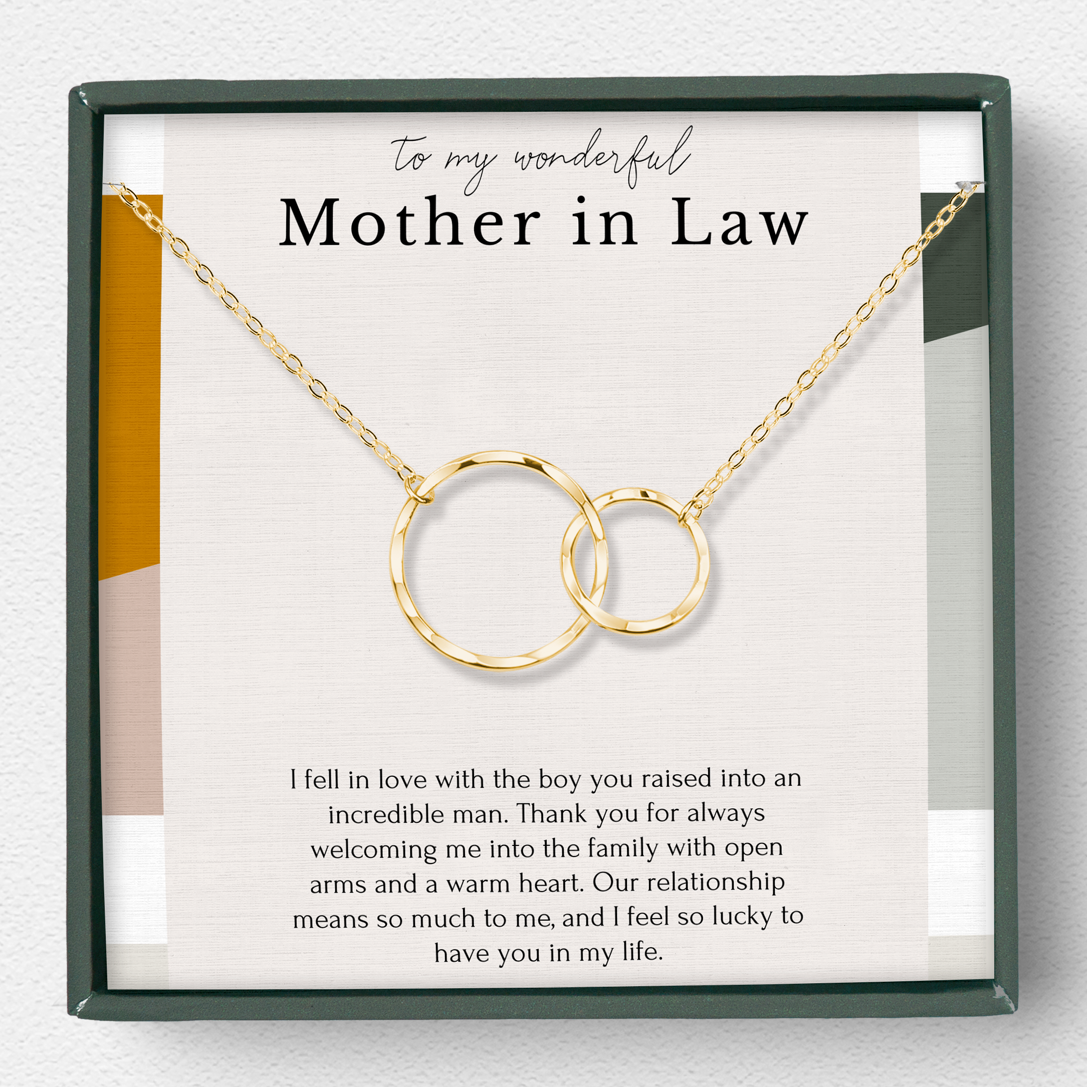 A gold vermeil necklace with two interlocking eternity circles and a freshwater pearl, presented in a jewelry box with a message to the mother-in-law.